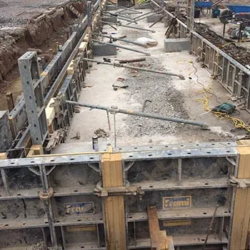 Steel shuttering panels propped along a deep reinforced foundation
