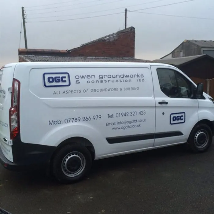 White OGC van with the company logo and phone numbers on the side