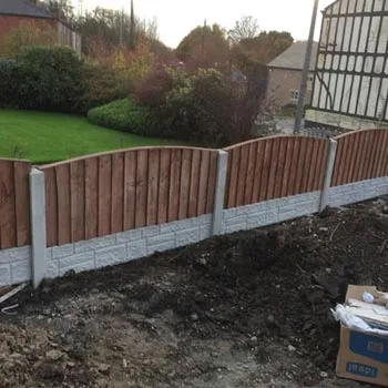 Timber panel fence on concrete posts and gravel boards in a garden