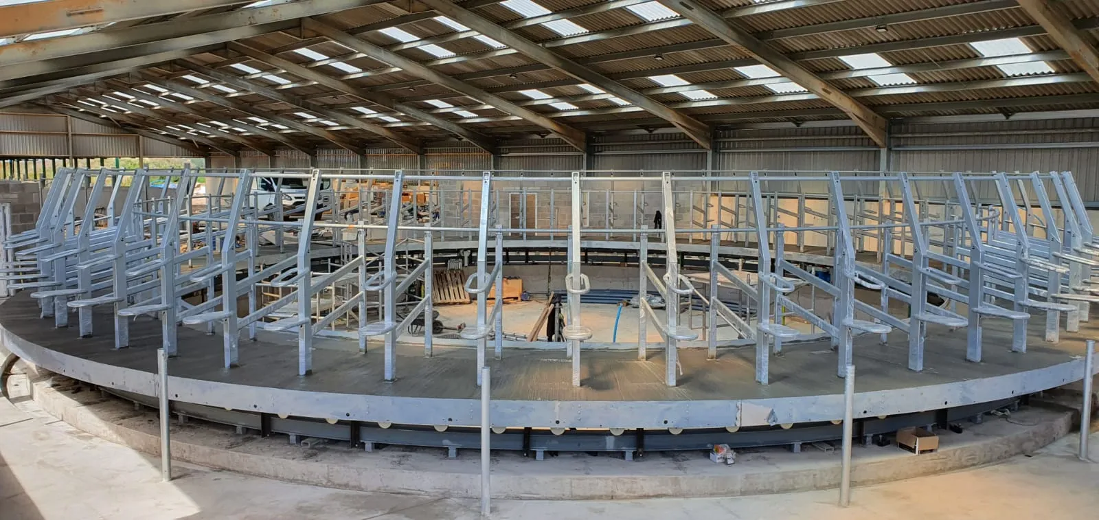 Completed rotary milking parlour with steel stalls sitting on the concrete base